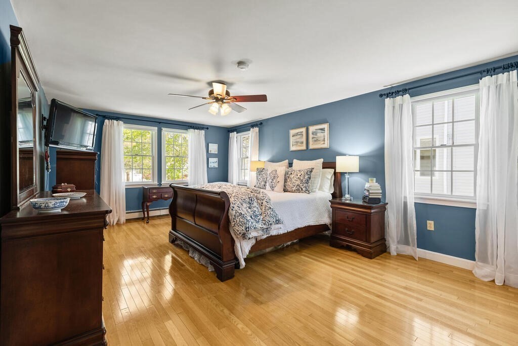 81 Baxter Street Melrose, MA 02176 - Photo 18 of 33 a bedroom with a bed and a chandelier