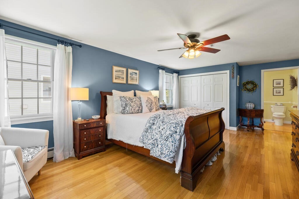 81 Baxter Street Melrose, MA 02176 - Photo 19 of 33 a bedroom with a bed and wooden floor