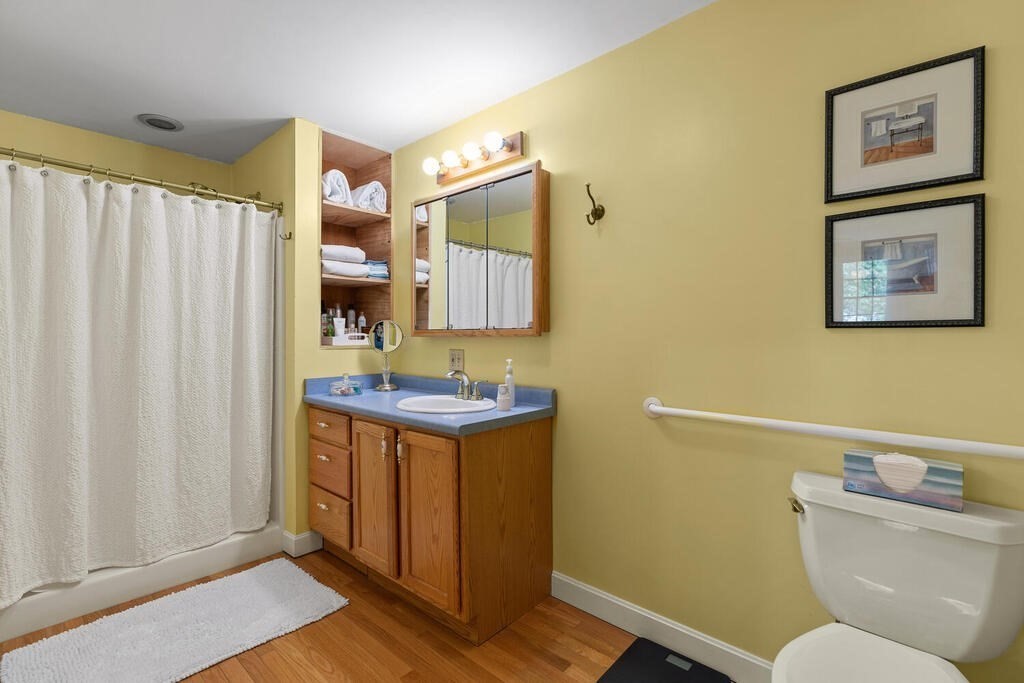 81 Baxter Street Melrose, MA 02176 - Photo 20 of 33 a bathroom with a toilet sink and mirror