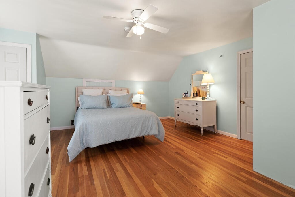 81 Baxter Street Melrose, MA 02176 - Photo 25 of 33 a bedroom with a bed and wooden floor
