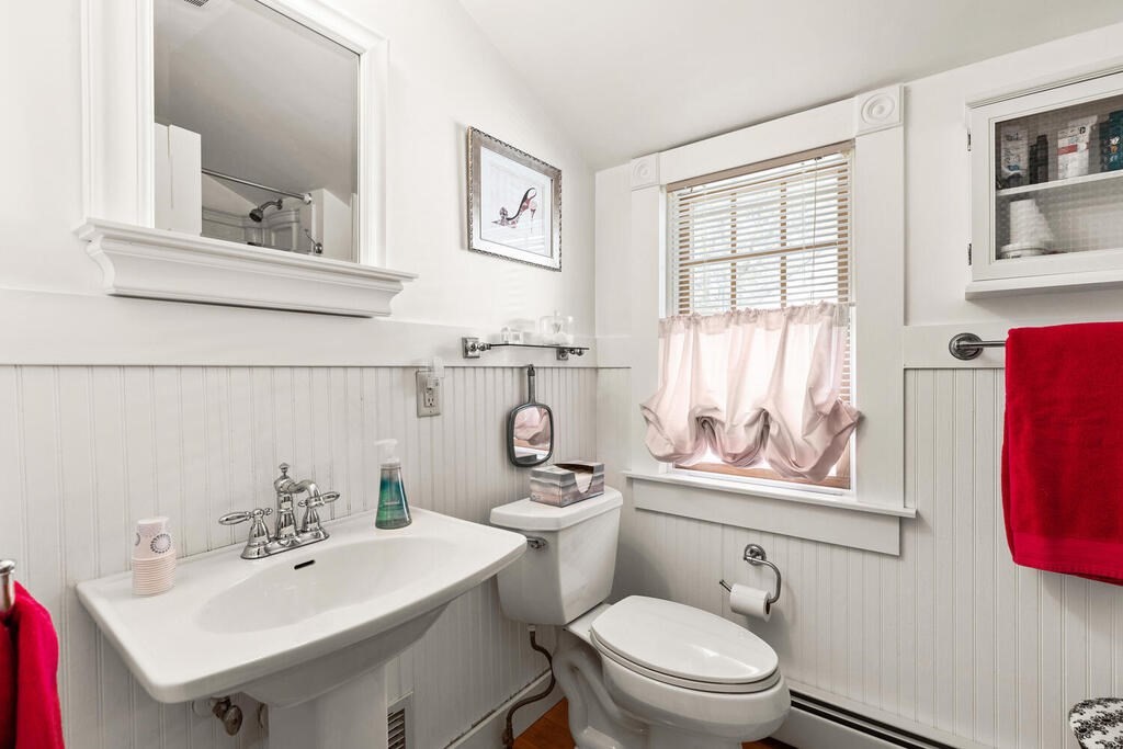 81 Baxter Street Melrose, MA 02176 - Photo 26 of 33 a bathroom with a sink a mirror and a toilet
