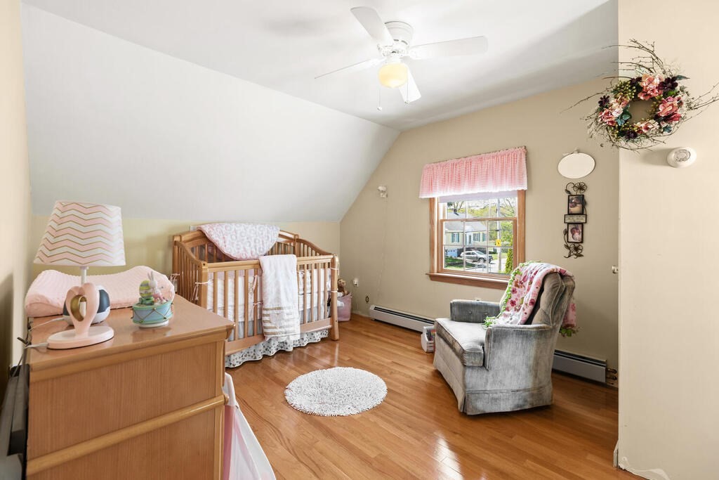 81 Baxter Street Melrose, MA 02176 - Photo 28 of 33 a living room with furniture and a chandelier