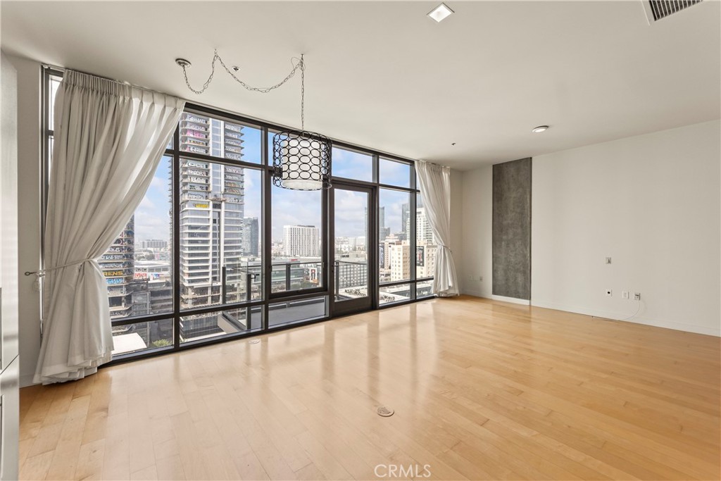 1100 South Hope Street, Unit 1704 Los Angeles, CA 90015 - Photo 11 of 26 a view of an empty room with a sliding door
