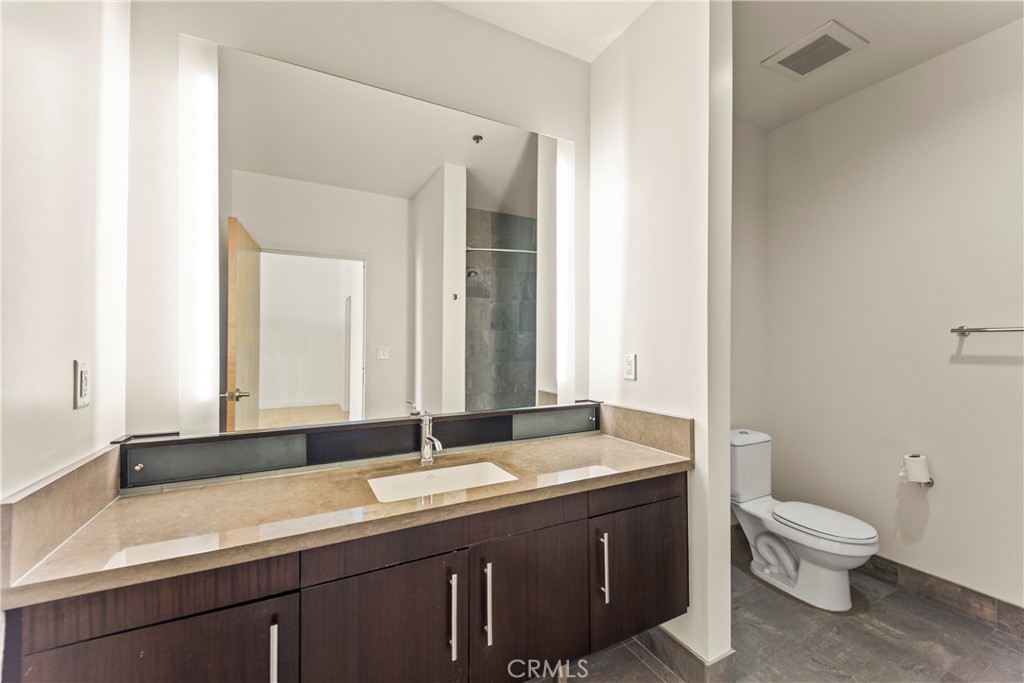 1100 South Hope Street, Unit 1704 Los Angeles, CA 90015 - Photo 16 of 26 a bathroom with a sink and a mirror
