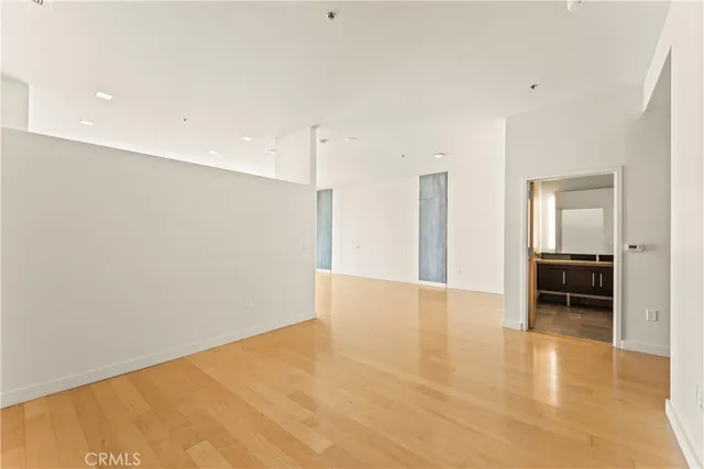 a view of an empty room with closet and a window