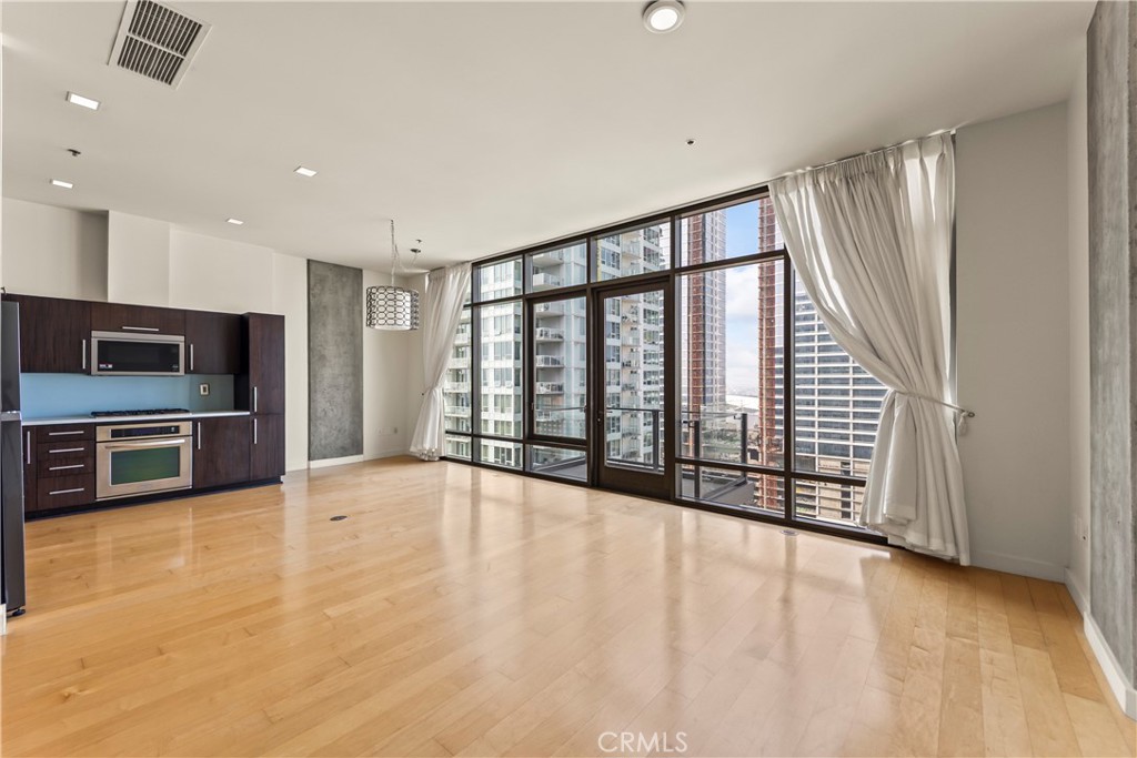 1100 South Hope Street, Unit 1704 Los Angeles, CA 90015 - Photo 8 of 26 a view of an empty room with a window and stainless steel appliances