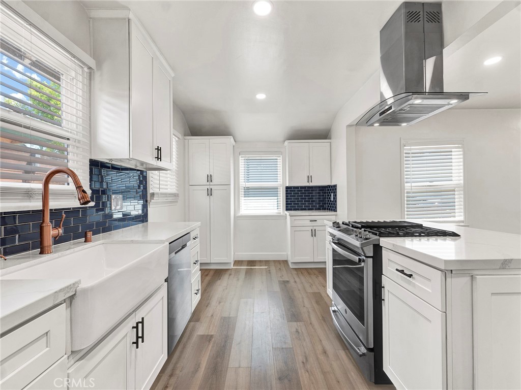 7517 Louise Avenue Lake Balboa, CA 91406 - Photo 6 of 18 a kitchen with stainless steel appliances granite countertop a sink stove and refrigerator