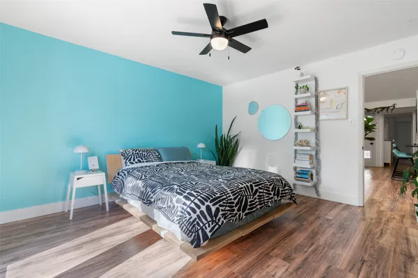 a bedroom with a bed dresser and a window