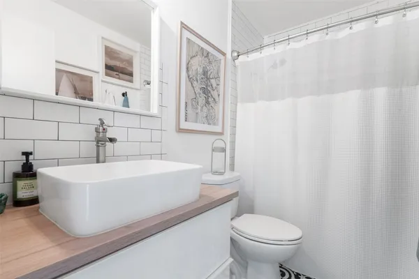 a white bath tub sitting next to a white toilet