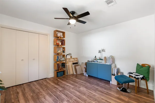a view of a workspace with furniture and wooden floor
