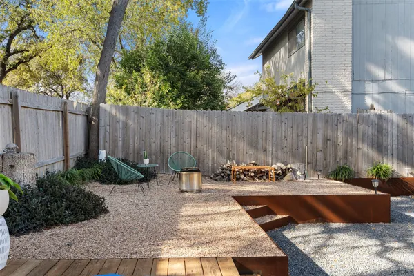 a view of a backyard with plants and tree