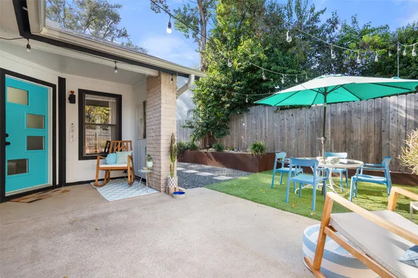a view of a backyard with a patio and a garden