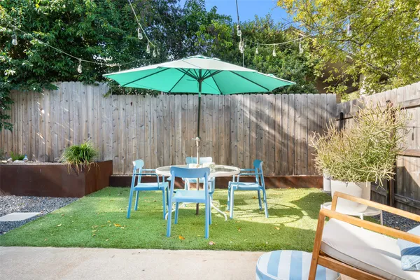 a view of backyard with seating area and green slide