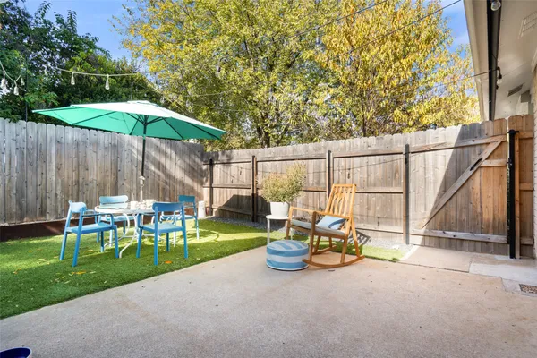 a view of a table and chairs under an umbrella
