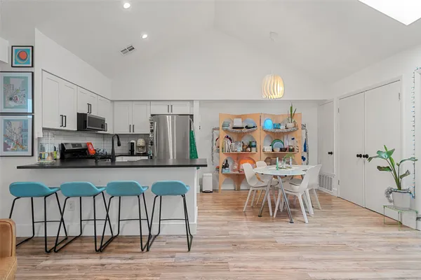 a view of a dining room with furniture and wooden floor