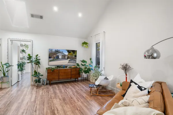 a living room with furniture and wooden floor