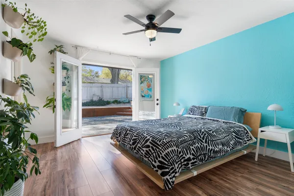 a bedroom with a bed and a potted plant