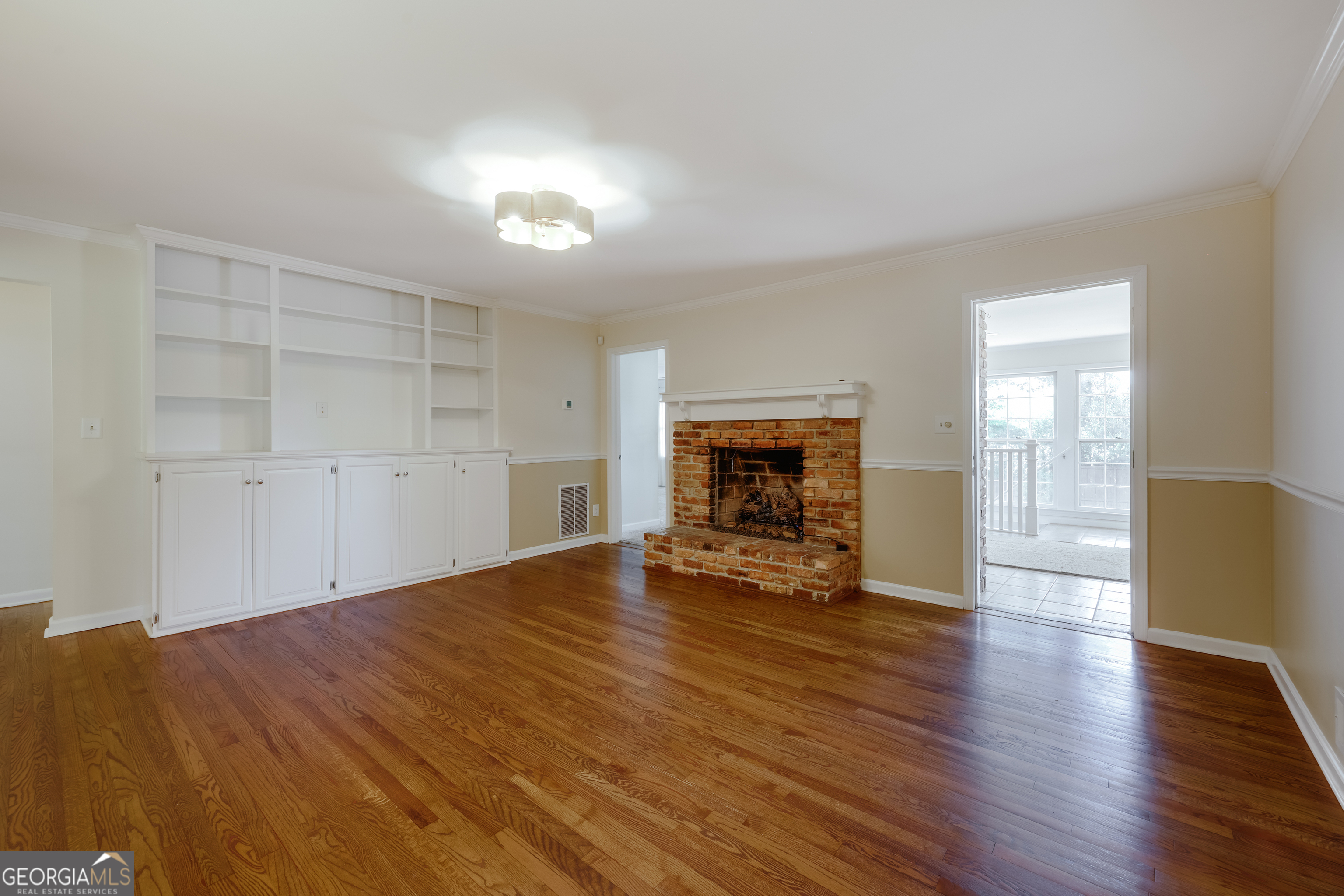 206 Fortson Drive Athens, GA 30606 - Photo 21 of 48 an empty room with wooden floor fireplace and windows