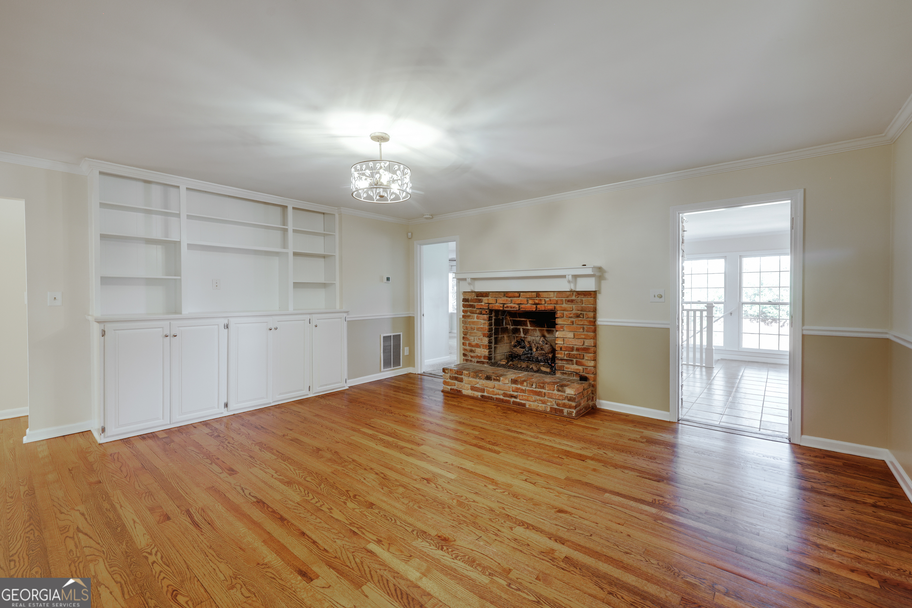 206 Fortson Drive Athens, GA 30606 - Photo 29 of 54 an empty room with wooden floor fireplace and windows