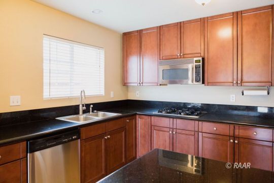 1633 South Farragut Street Ridgecrest, CA 93555 - Photo 6 of 30 a kitchen with granite countertop cabinets sink and window