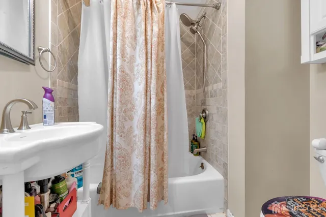 a bathroom with a sink a bathtub and a shower