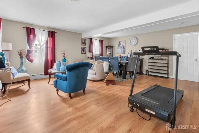 a living room with furniture a table and wooden floor