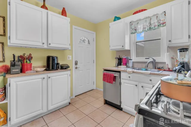 a utility room with cabinets washer and dryer