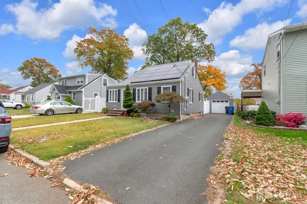 a street view with tall buildings and a yard