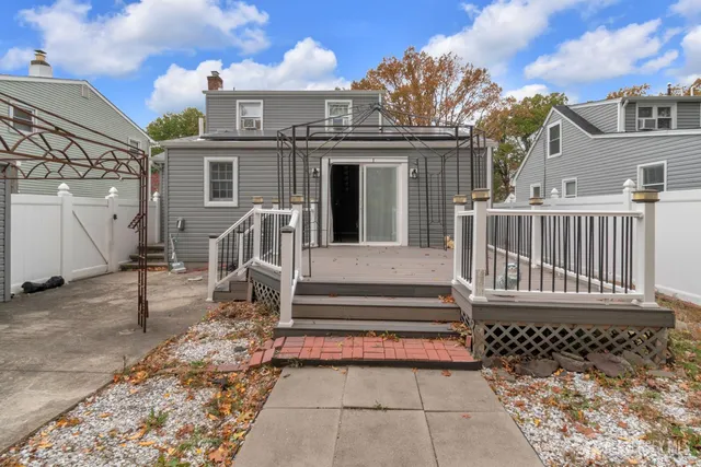 a view of a house with wooden fence