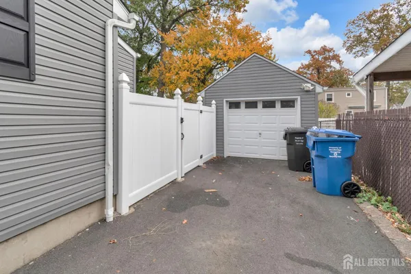 a view of a house with a yard and a garage