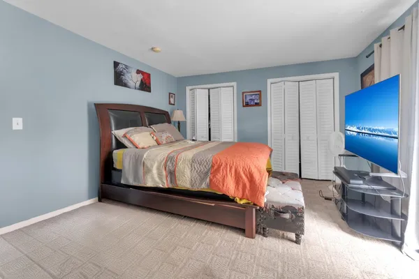 a bedroom with a bed and a cabinets