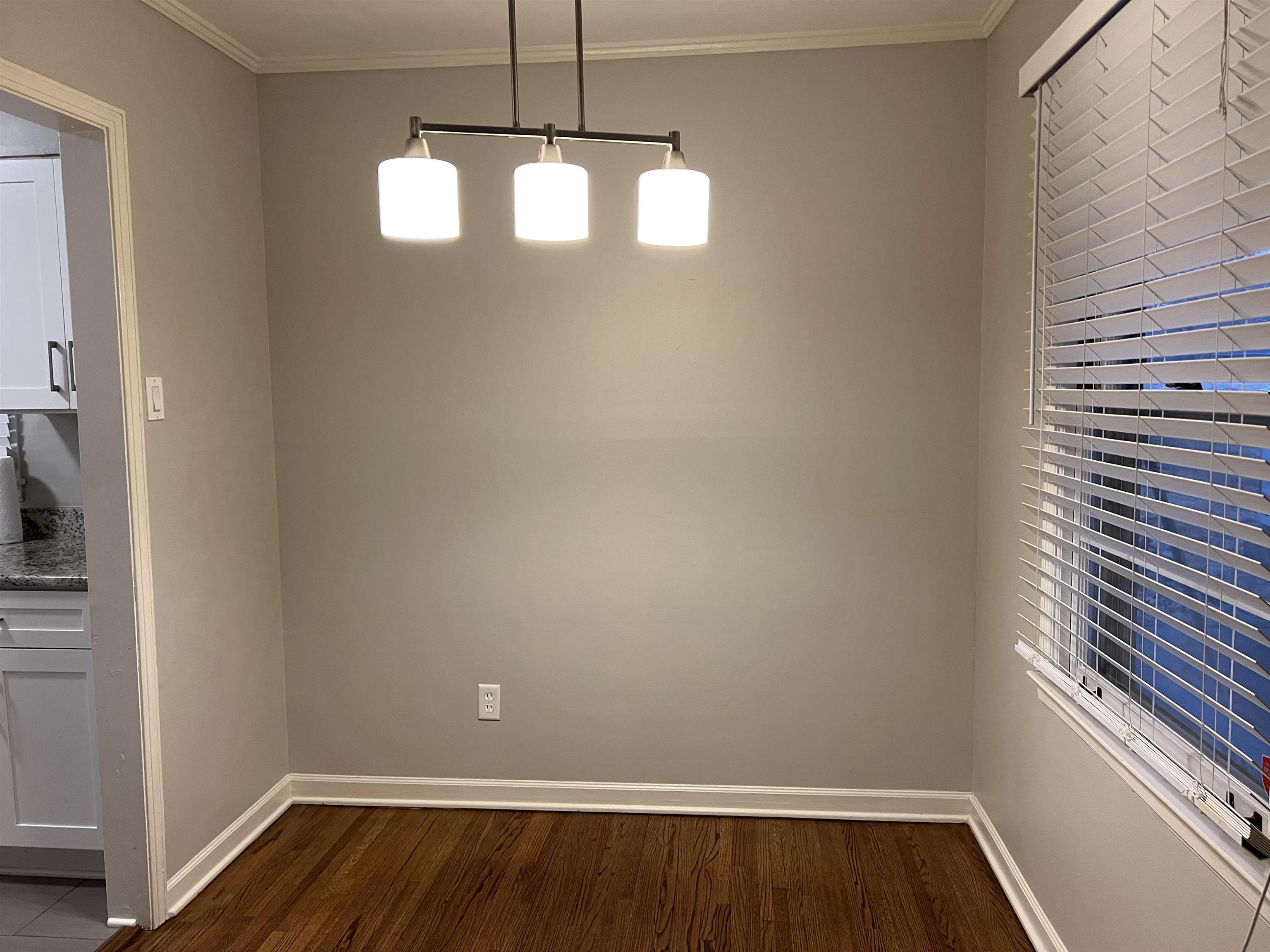 1653 Colonial Road Memphis, TN 38117 - Photo 3 of 15 a view of a room with wooden floor and chandelier