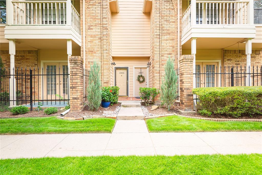 Property entrance with a balcony and brick siding