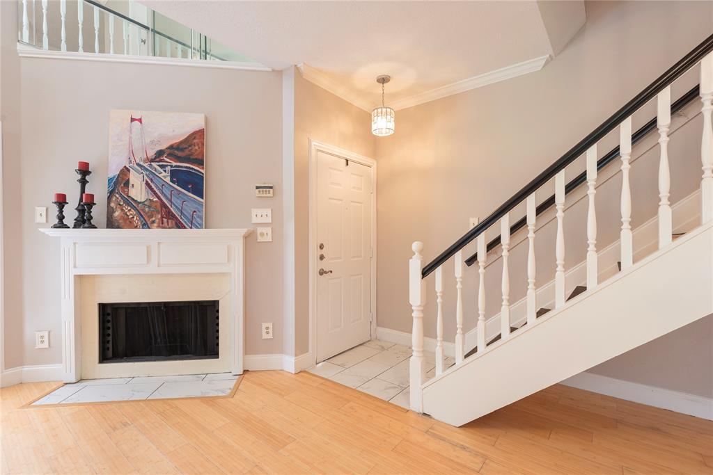 14333 Preston Road, Unit 2807 Dallas, TX 75254 - Photo 7 of 31 Foyer entrance featuring wood finished floors, a fireplace, ornamental molding, and stairs