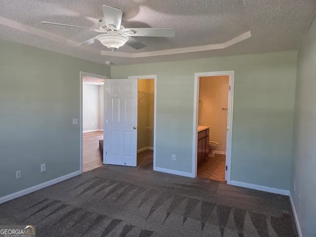 a view of an empty room with a ceiling fan