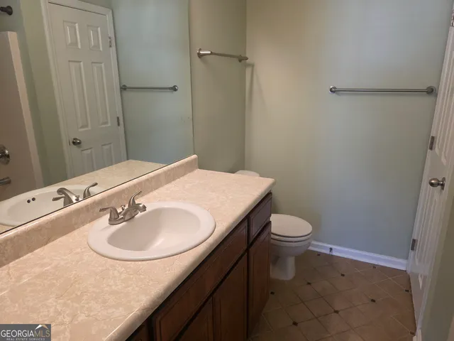 a bathroom with a sink toilet and vanity