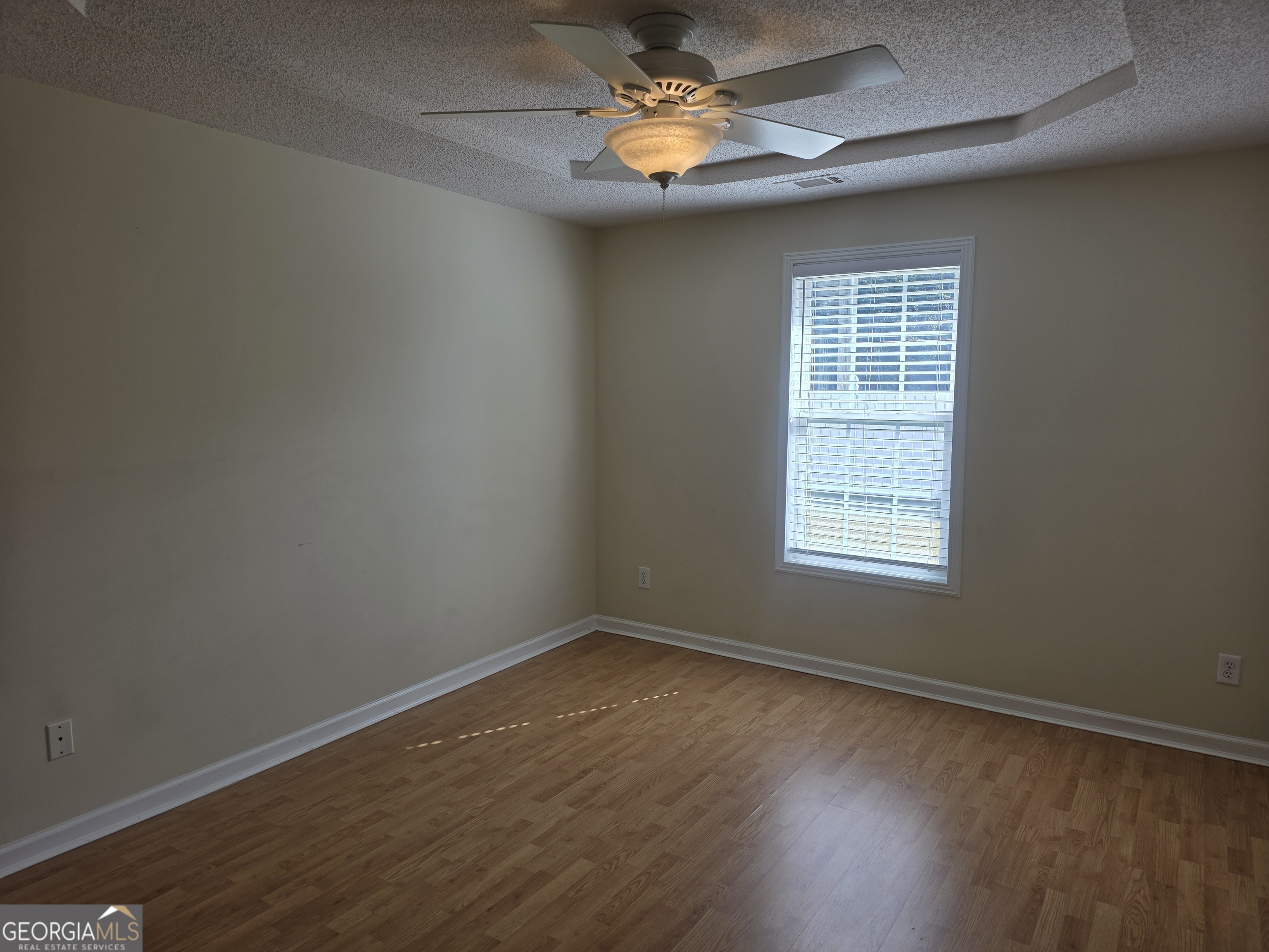 103 Reese Way Rincon, GA 31326 - Photo 15 of 21 an empty room with a window and wooden floor
