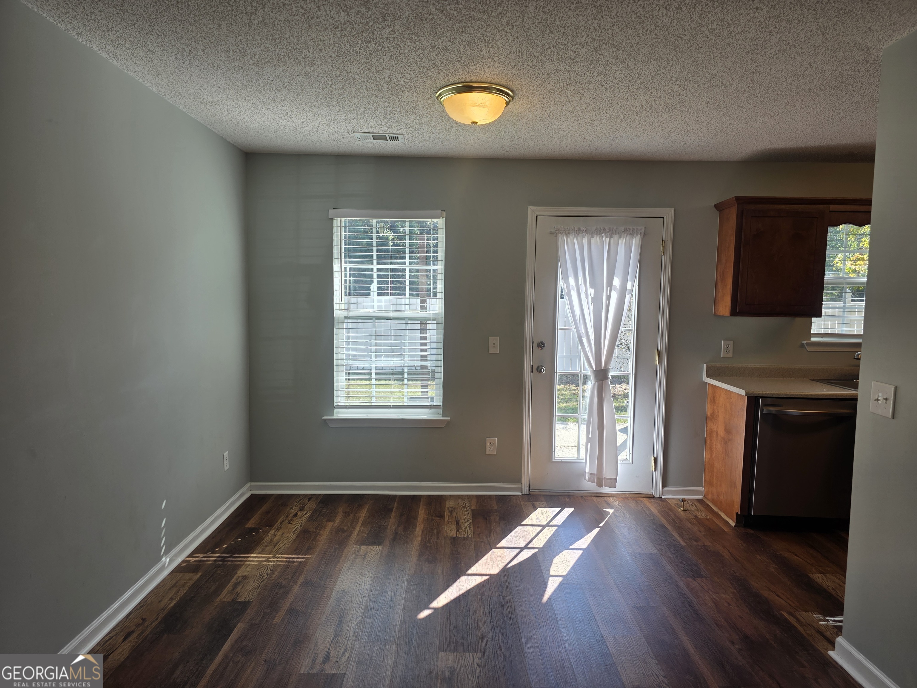 103 Reese Way Rincon, GA 31326 - Photo 6 of 21 an empty room with wooden floor fireplace and windows