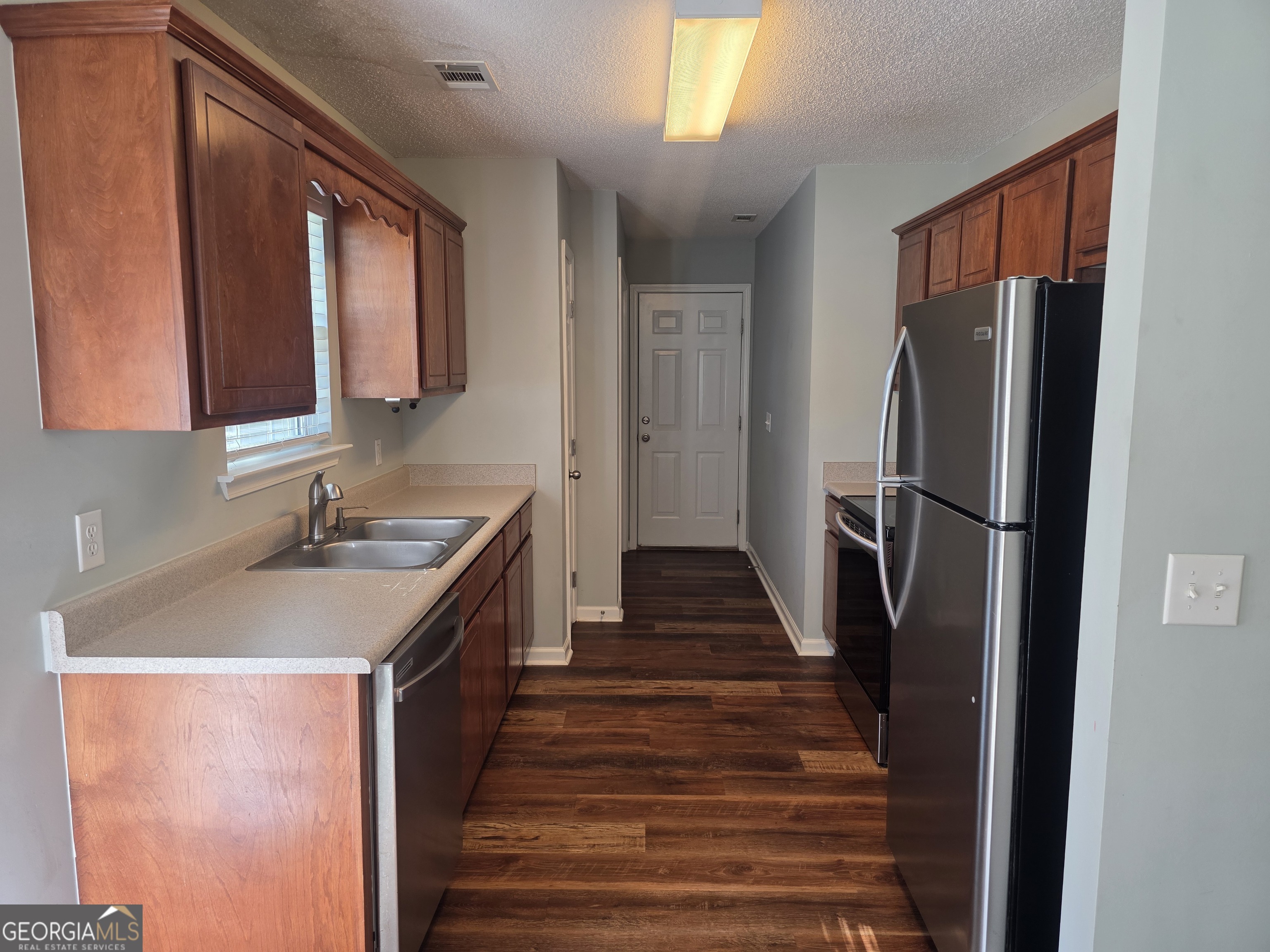 103 Reese Way Rincon, GA 31326 - Photo 7 of 21 a kitchen with sink a refrigerator and a stove