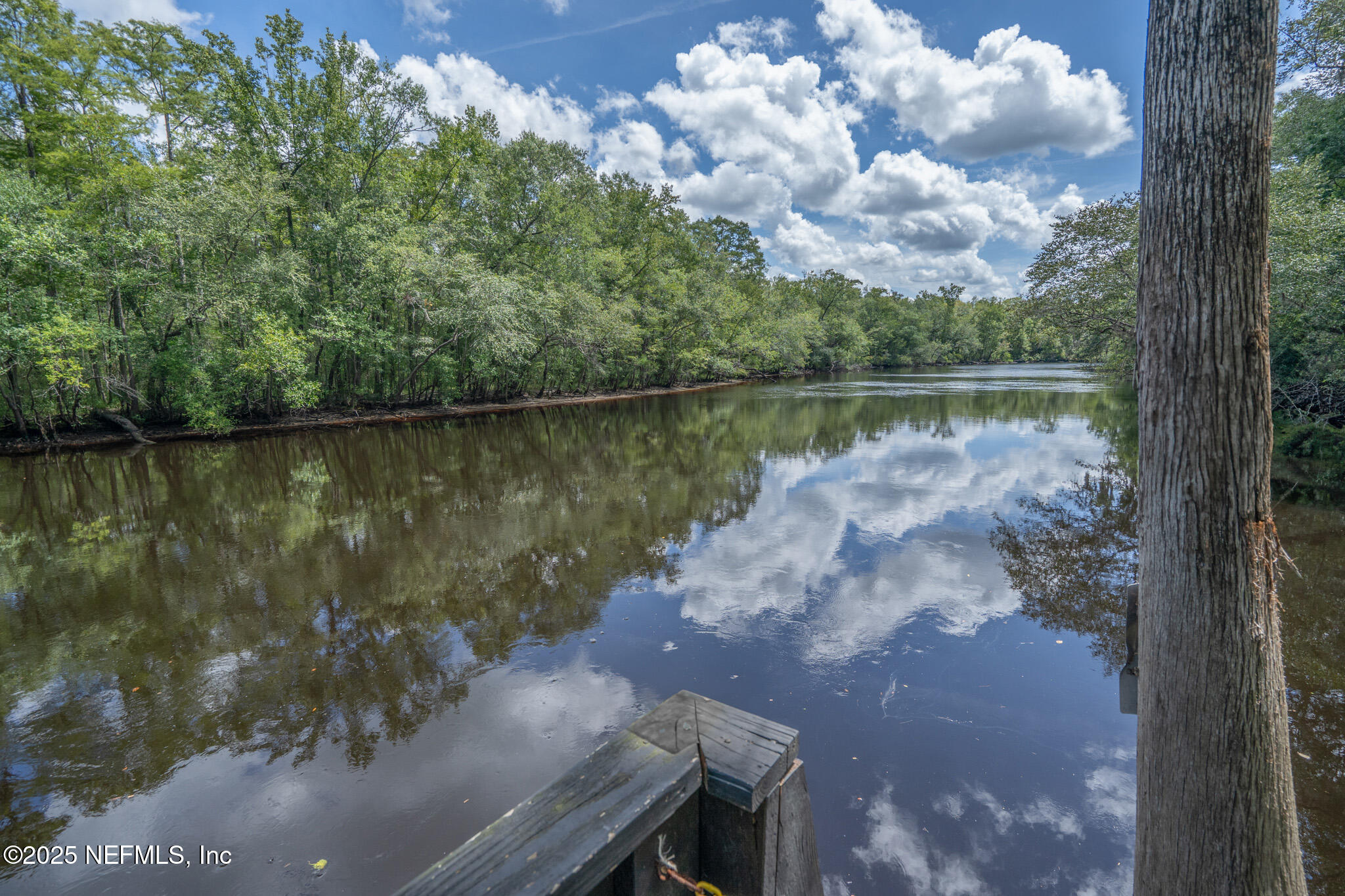 181040 Autumn Road Hilliard, FL 32046 - Photo 17 of 46 a view of a lake in between two large trees