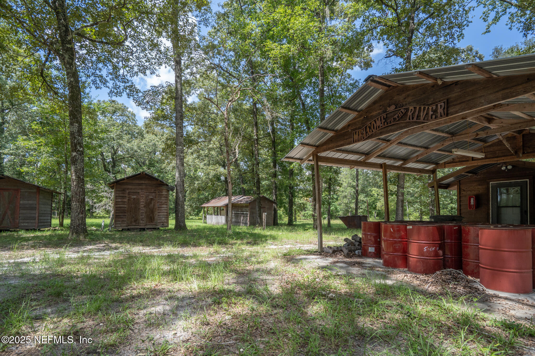 181040 Autumn Road Hilliard, FL 32046 - Photo 31 of 46 a view of a backyard with large trees and plants