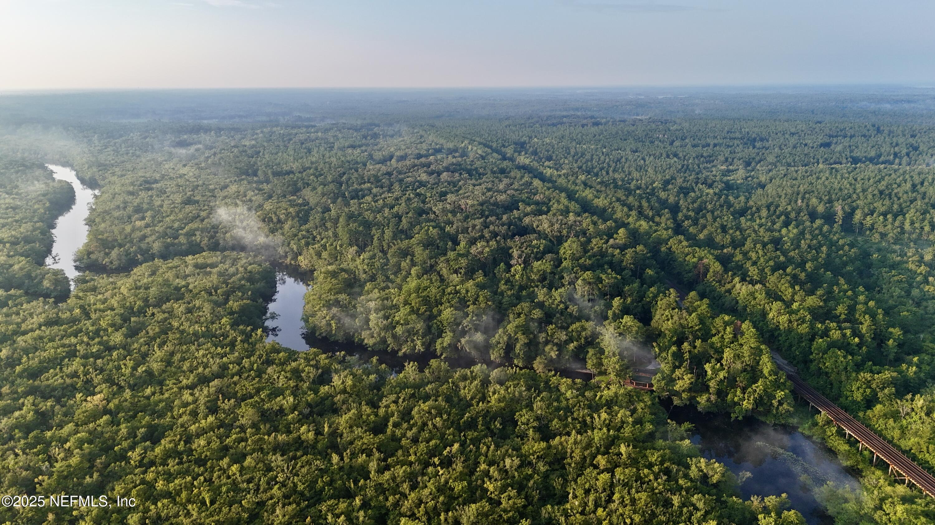 181040 Autumn Road Hilliard, FL 32046 - Photo 44 of 46 a view of a field of grass and trees
