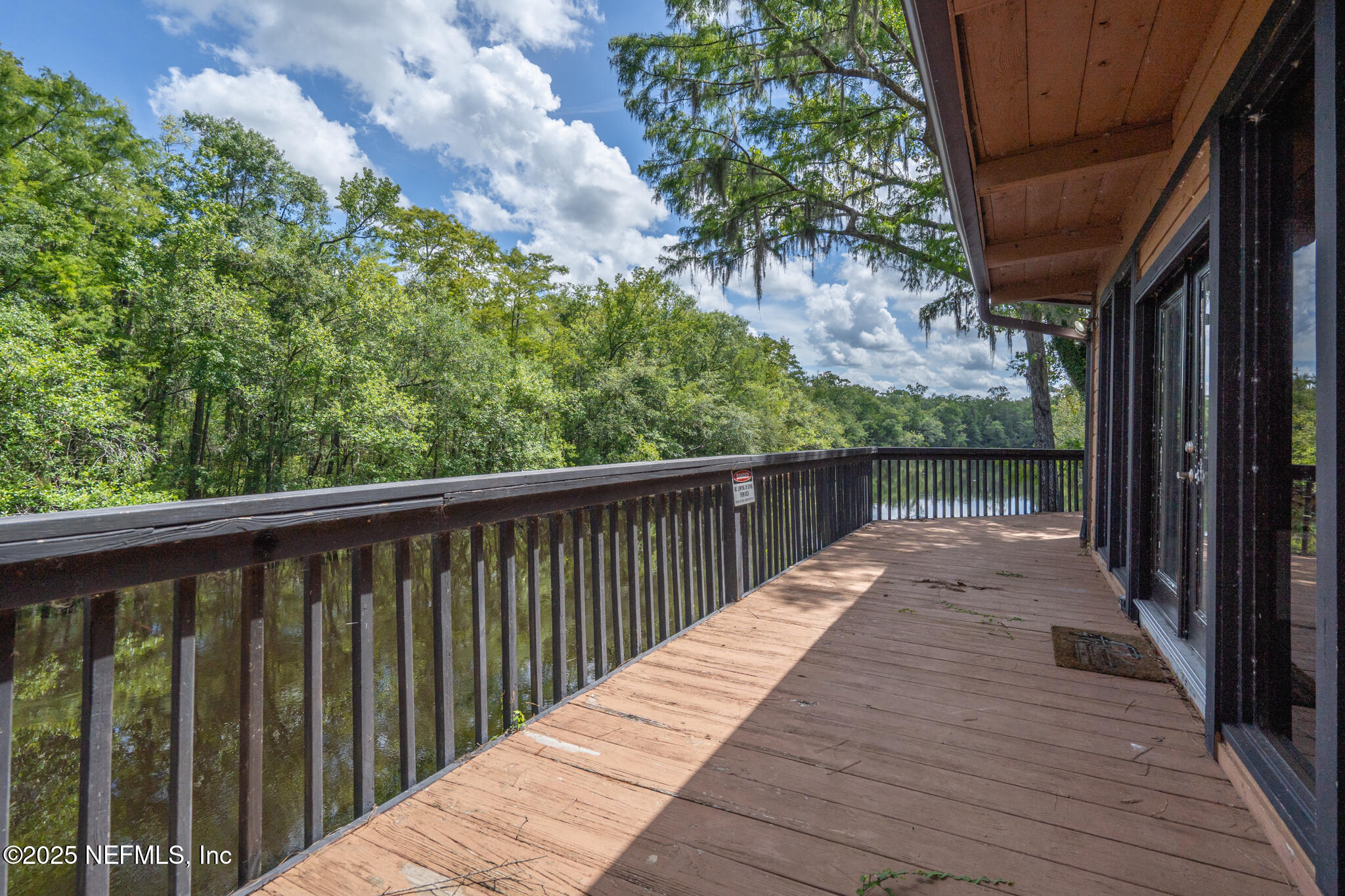 181040 Autumn Road Hilliard, FL 32046 - Photo 6 of 46 a balcony with wooden floor and fence