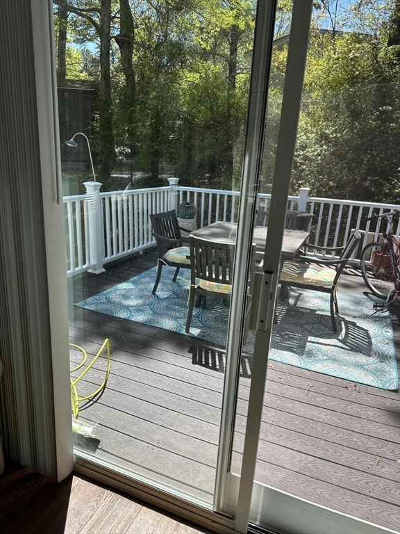 185 Cotuit Road, Unit 1 JUNIPER Sandwich, MA 02563 - Photo 11 of 11 a view of a wooden deck with chairs