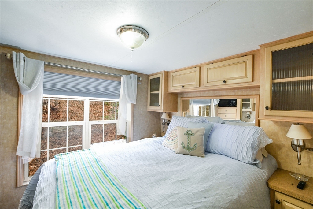 185 Cotuit Road, Unit 1 JUNIPER Sandwich, MA 02563 - Photo 13 of 20 a bedroom with a large bed and a window