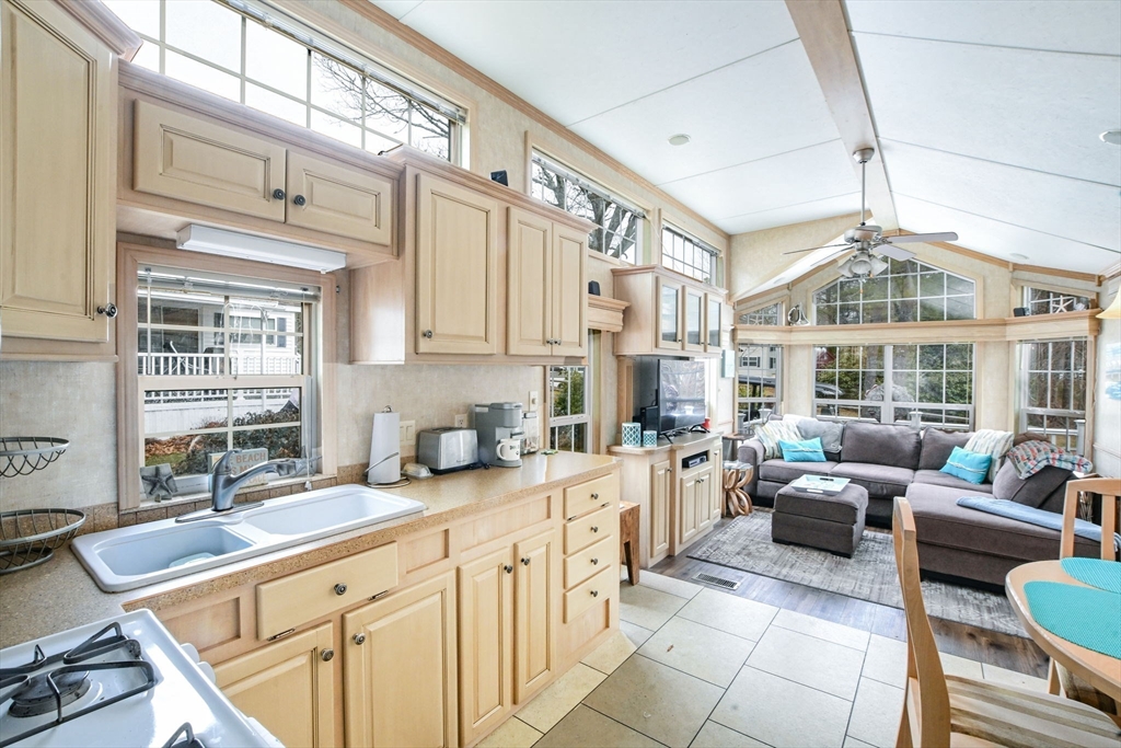 185 Cotuit Road, Unit 1 JUNIPER Sandwich, MA 02563 - Photo 7 of 20 a kitchen with stainless steel appliances granite countertop a sink and cabinets