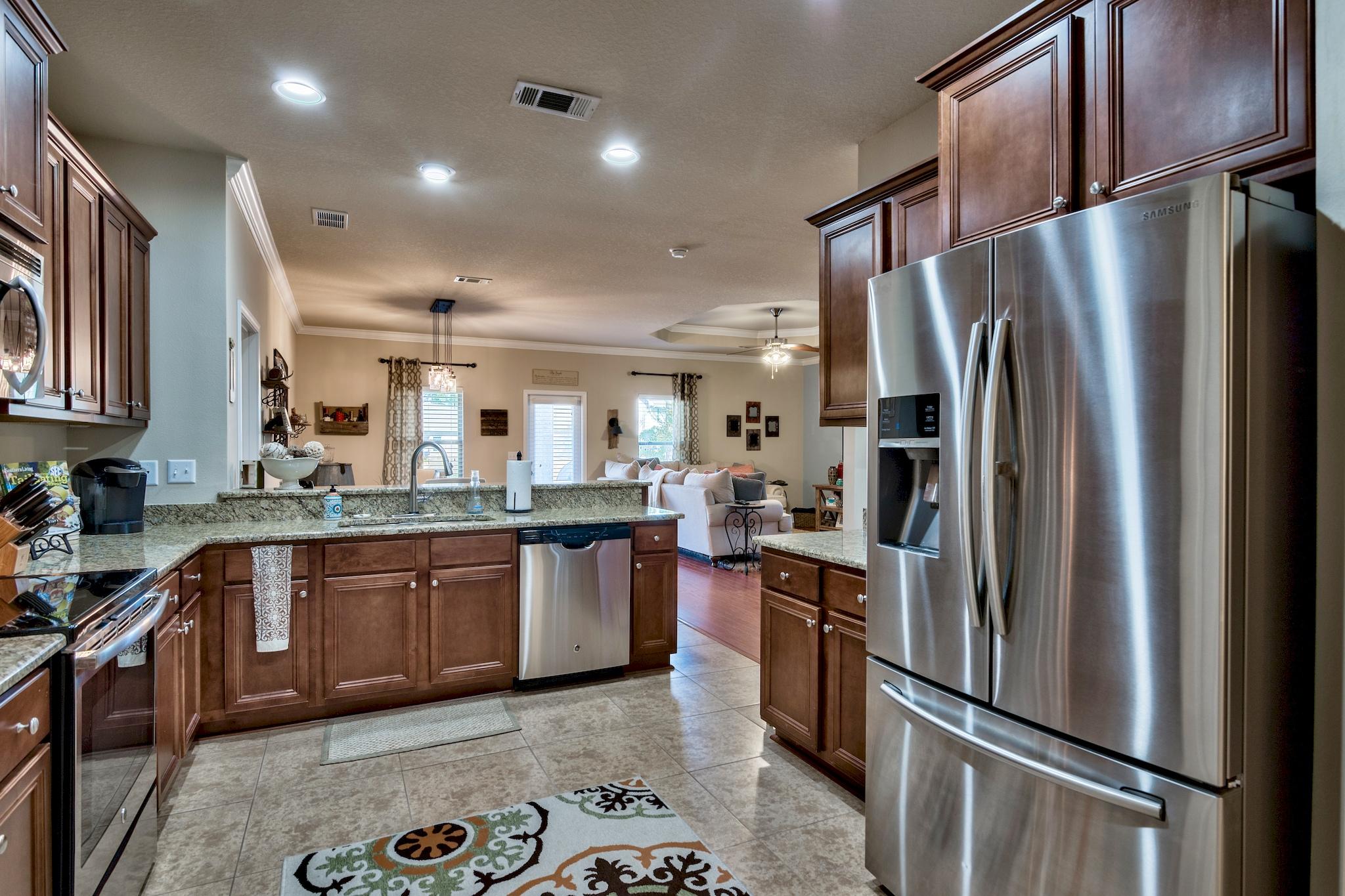 86 Pin Oak Loop Santa Rosa Beach, FL 32459 - Photo 5 of 28 a kitchen with stainless steel appliances granite countertop a refrigerator sink and stove