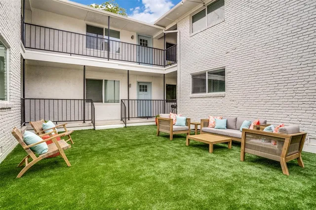 a backyard of a house with table and chairs