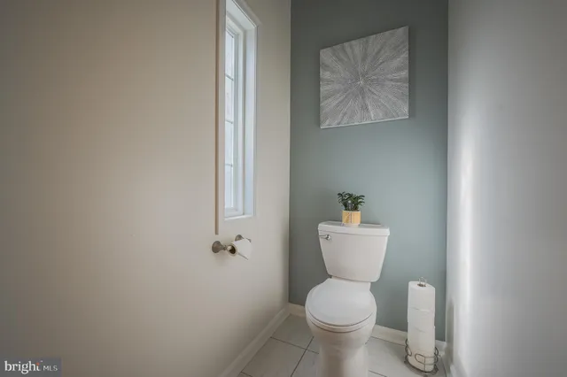 a white toilet sitting next to a bathroom sink