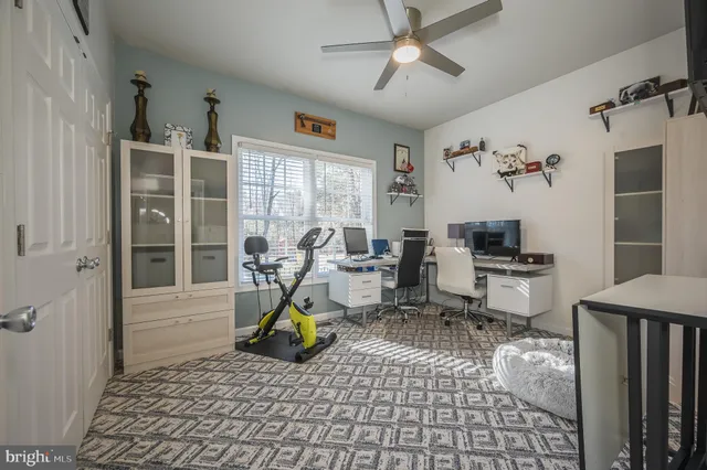 a view of a workspace with furniture and a window